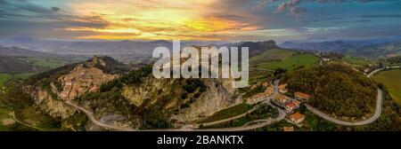 San Leo town and fortress prison during dramatic sunset in Italy Stock Photo