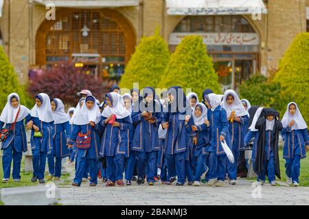 Elementary school girls on Imam Square in front of the Ali Qapu Palace in Isfahan Stock Photo