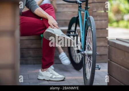Young man in red pants next to the track bike Stock Photo