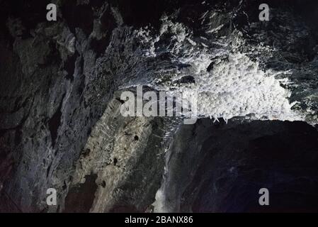 Nemocon, Cundinamarca / Colombia; March 24, 2018: interior of a salt mine open for sightseeing tours, ceiling of a tunnel covered in salt formations Stock Photo