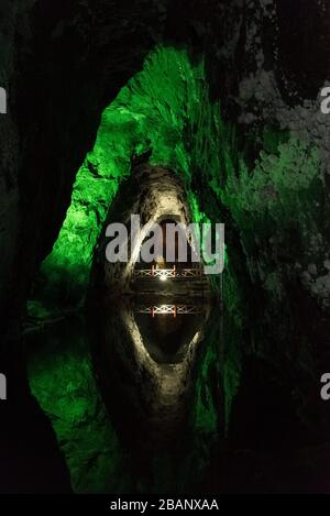Nemocon, Cundinamarca / Colombia; March 24, 2018: mirror of water and walls illuminated with green lights inside a salt mine, open for sightseeing tou Stock Photo