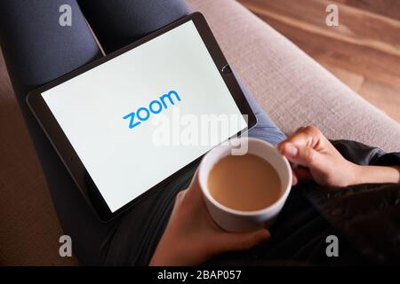 Portland, OR, USA - Mar 28, 2020: A woman using Zoom mobile app to join a meeting from her iPad. Zoom is a cloud-based video conferencing tool. Stock Photo