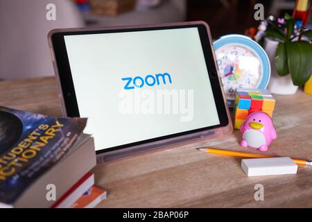 Zoom mobile app page on a iPad. As Covid-19 leads to cities quarantined, Zoom emerges as one of the tools to keep business up and students learning. Stock Photo