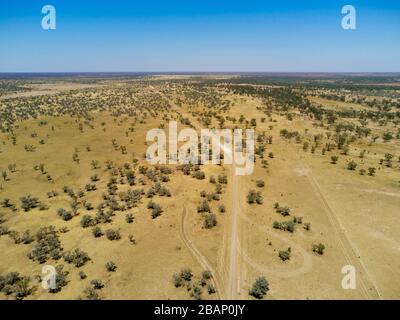 Aerial of unsealed road passing through Bulloo River flood plain during an extended drought Thargomindah Bulloo Shire Queensland Australia Stock Photo