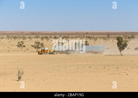 Road train travelling along the dusty unsealed Strzelecki Track in outback South Australia Stock Photo