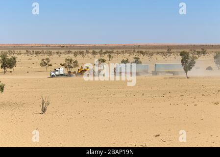 Road train travelling along the dusty unsealed Strzelecki Track in outback South Australia Stock Photo