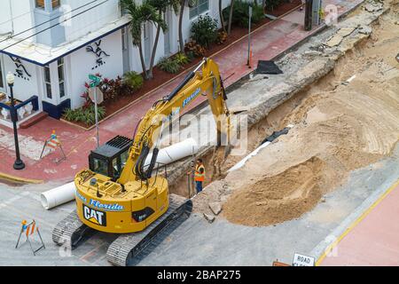 Miami Beach Florida,road repair,renovation,capital improvements,Caterpillar,shovel,excavator,equipment,under new construction site building builder,la Stock Photo