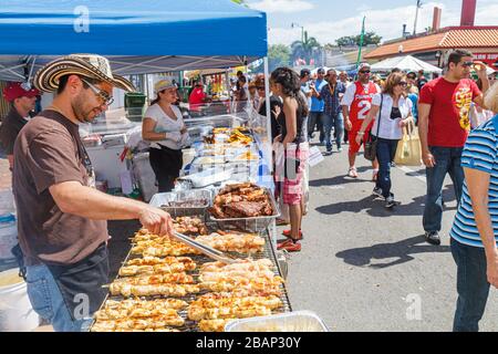 Miami Florida,Little Havana,Calle Ocho Street Festival,Hispanic celebration,man men male adult adults,cook,cooking,vendor vendors stall stalls booth m Stock Photo