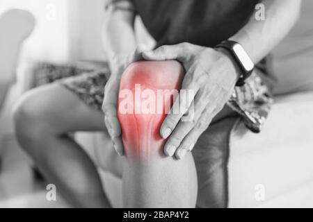Joint pain, Arthritis and tendon problems. a man touching nee at pain point Stock Photo