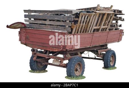 Old red rural tractor trailer cart wuith wooden logs in  truck body isolated on white Stock Photo