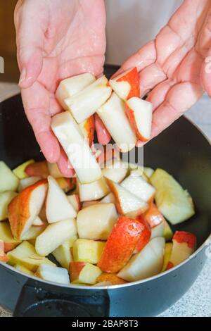 Miami Beach Florida,making fruit fruits compote apples pears,limes cranberries hands cutting slicing preparing cooking mixing combining, Stock Photo