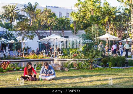 Miami Beach Florida,Miami Beach,Botanical Garden,Art Basel,cafe,al fresco sidewalk outside outdoors tables,dining,table,umbrellas,adult adults man men Stock Photo