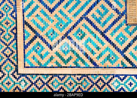 Ceramic tiles corner in Ulugh Beg Madrasah. Located in the Registan Square, Samarkand, Uzbekistan. Ceramic details in shades of cyan, blue and green. Stock Photo