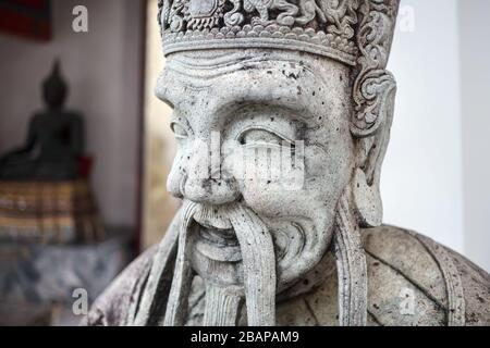 Stone statue of monk in Buddhist Temple Wat Pho in Bangkok, Thailand Stock Photo