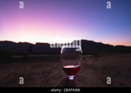 Wineglas in africa with the sunset in background Stock Photo