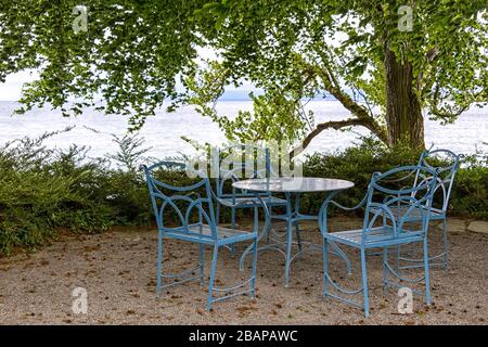 A wonderful outdoor seating area, at Lake Constance, in the park of the Mainau flower island in Konstanz, Germany. The lake is situated in Germany, Sw Stock Photo