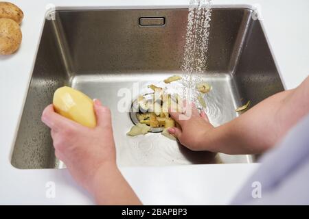 Food waste disposer machine in sink in modern kitchen Stock Photo