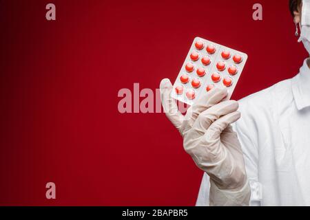 female in gloves showing pills in studio Stock Photo