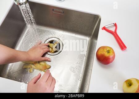 Food waste disposer machine in sink in modern kitchen Stock Photo