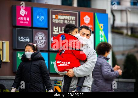 Father and his young son wearing masks during the Coronavirus pandemic, Seoul, South Korea Stock Photo