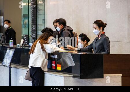 Reception wearing masks at an office building during the Coronavirus pandemic, Seoul, South Korea Stock Photo