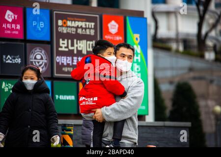 Father and his young son wearing masks during the Coronavirus pandemic, Seoul, South Korea Stock Photo