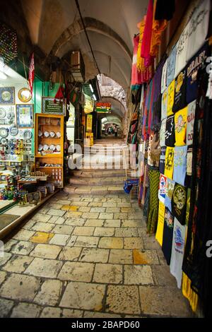 jerusalem Narrow stone street among stalls with traditional souvenirs and goods at bazaar  in Old City of Jerusalem, Israel Stock Photo