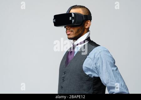 African-american Business man using a virtual reality VR headset Stock Photo