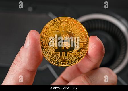 Closeup Of Hand Holding Bitcoin Crypto Currency Coin Stock Photo
