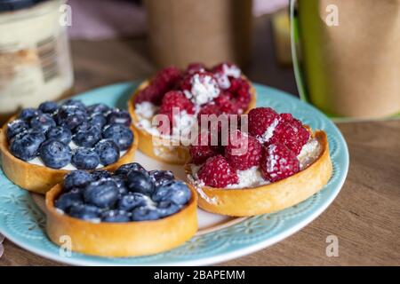 Delicious Tartlets from shortcrust pastry with Blueberries and Raspberries. Healthy pastries Stock Photo