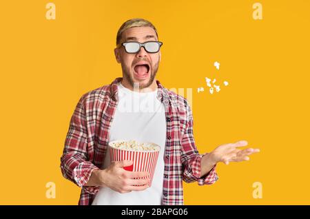 Scared guy in 3d glasses tossed popcorn Stock Photo