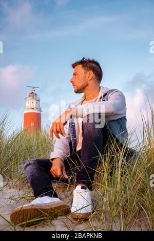 Texel lighthouse during sunset Netherlands Dutch Island Texel, couple visit the lighthouse , men and woman on vacation Texel Stock Photo