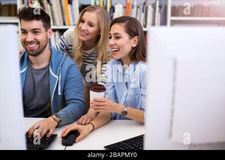 University students working in the library at campus Stock Photo