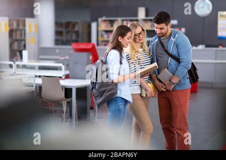 University students working in the library at campus Stock Photo