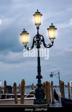 Lamppost with pink glass in Venice, Italy, at dawn by the Grand Canal ...