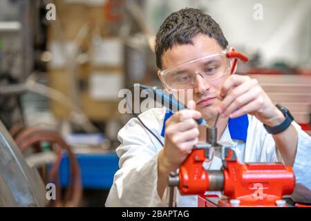 scientist in the development center makes a part for a new device Stock Photo