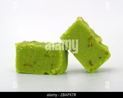 Close Up Of Two Pieces Of Delicious Pistachio Burfi, London, UK On A White Background Stock Photo