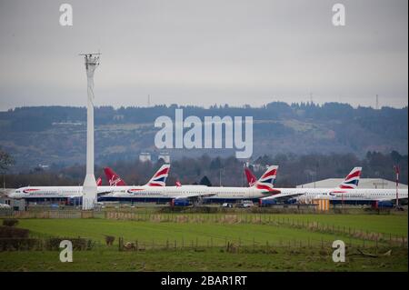 Glasgow, UK. 27 March 2020. Pictured: British Airways Airbus Aircraft stand grounded on the tarmac at Glasgow Airport. The group of Airbus Aircraft comprise of Airbus A321, A320 and one A319 aircraft. Credit: Colin Fisher/Alamy Live News. Stock Photo