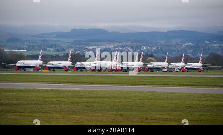 Glasgow, UK. 27 March 2020. Pictured: British Airways Airbus Aircraft stand grounded on the tarmac at Glasgow Airport. The group of Airbus Aircraft comprise of Airbus A321, A320 and one A319 aircraft. Credit: Colin Fisher/Alamy Live News. Stock Photo