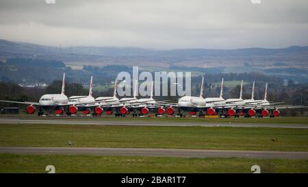 Glasgow, UK. 27 March 2020. Pictured: British Airways Airbus Aircraft stand grounded on the tarmac at Glasgow Airport. The group of Airbus Aircraft comprise of Airbus A321, A320 and one A319 aircraft. Credit: Colin Fisher/Alamy Live News. Stock Photo