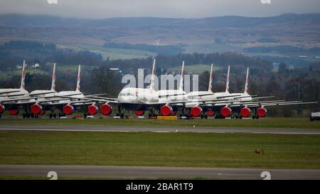 Glasgow, UK. 27 March 2020. Pictured: British Airways Airbus Aircraft stand grounded on the tarmac at Glasgow Airport. The group of Airbus Aircraft comprise of Airbus A321, A320 and one A319 aircraft. Credit: Colin Fisher/Alamy Live News. Stock Photo