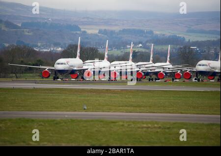 Glasgow, UK. 27 March 2020. Pictured: British Airways Airbus Aircraft stand grounded on the tarmac at Glasgow Airport. The group of Airbus Aircraft comprise of Airbus A321, A320 and one A319 aircraft. Credit: Colin Fisher/Alamy Live News. Stock Photo