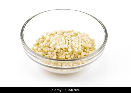 minced almonds in a small glass bowl isolated on white copy space Stock Photo