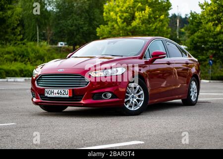 Ford Mondeo MK5 Titanium trim, in Ruby red coloud, sedan, photosession in an empty parking lot. Isolated car, nice photos Stock Photo