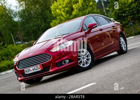 Ford Mondeo MK5 Titanium trim, in Ruby red coloud, sedan, photosession in  an empty parking lot. Isolated car, nice photos Stock Photo - Alamy