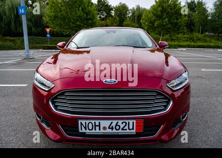 Ford Mondeo MK5 Titanium trim, in Ruby red coloud, sedan, photosession in an empty parking lot. Isolated car, nice photos Stock Photo