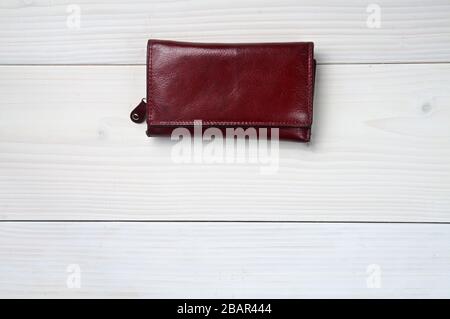 Brown leather purse on a white wooden background Stock Photo