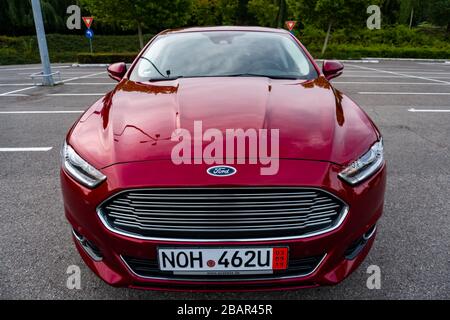 Ford Mondeo MK5 Titanium trim, in Ruby red coloud, sedan, photosession in an empty parking lot. Isolated car, nice photos Stock Photo