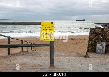 Myrtleville, Cork, Ireland. 29th March, 2020. Public Health notice with advice on social distancing in relation to the Covid-19 outreak on the slipway to Myrtleville Beach, Co. Co. Cork. Ireland. - Credit; David Creedon / Alamy Live News Stock Photo