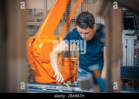 setup and service of the production line with robotic arms in the factory Stock Photo